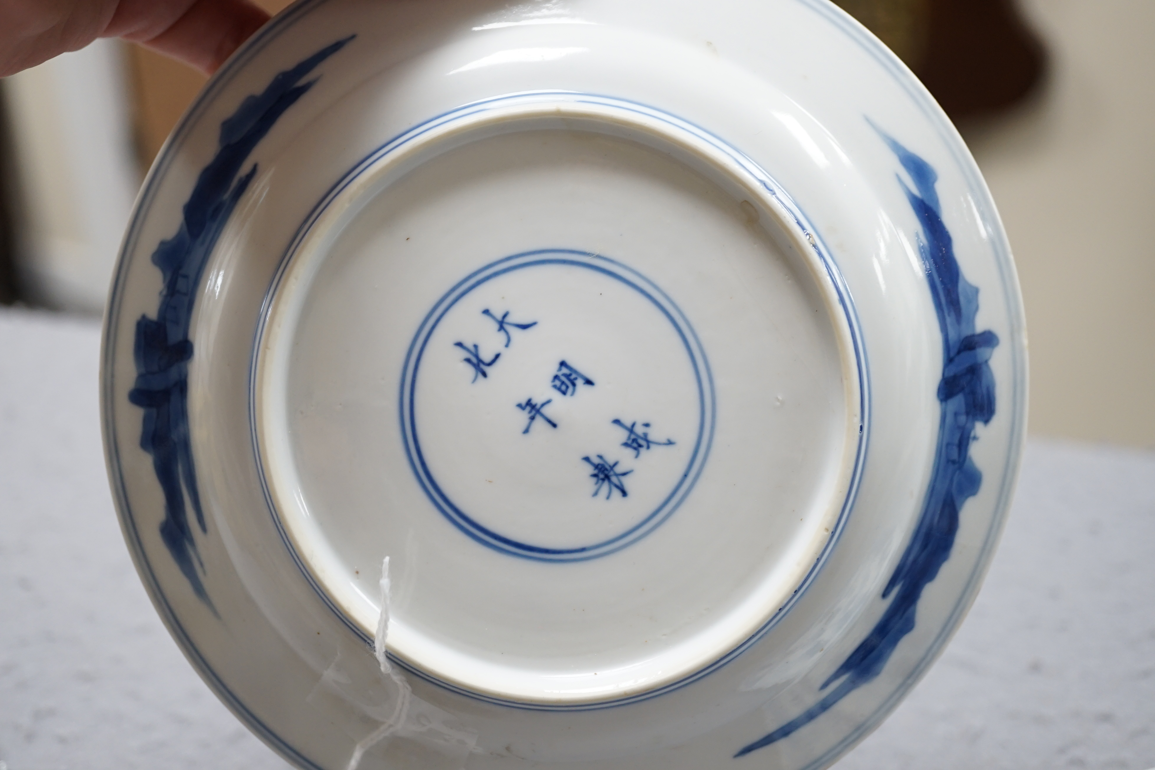 A pair of Chinese blue and white small plates, Kangxi period, hairline cracks to one plate.